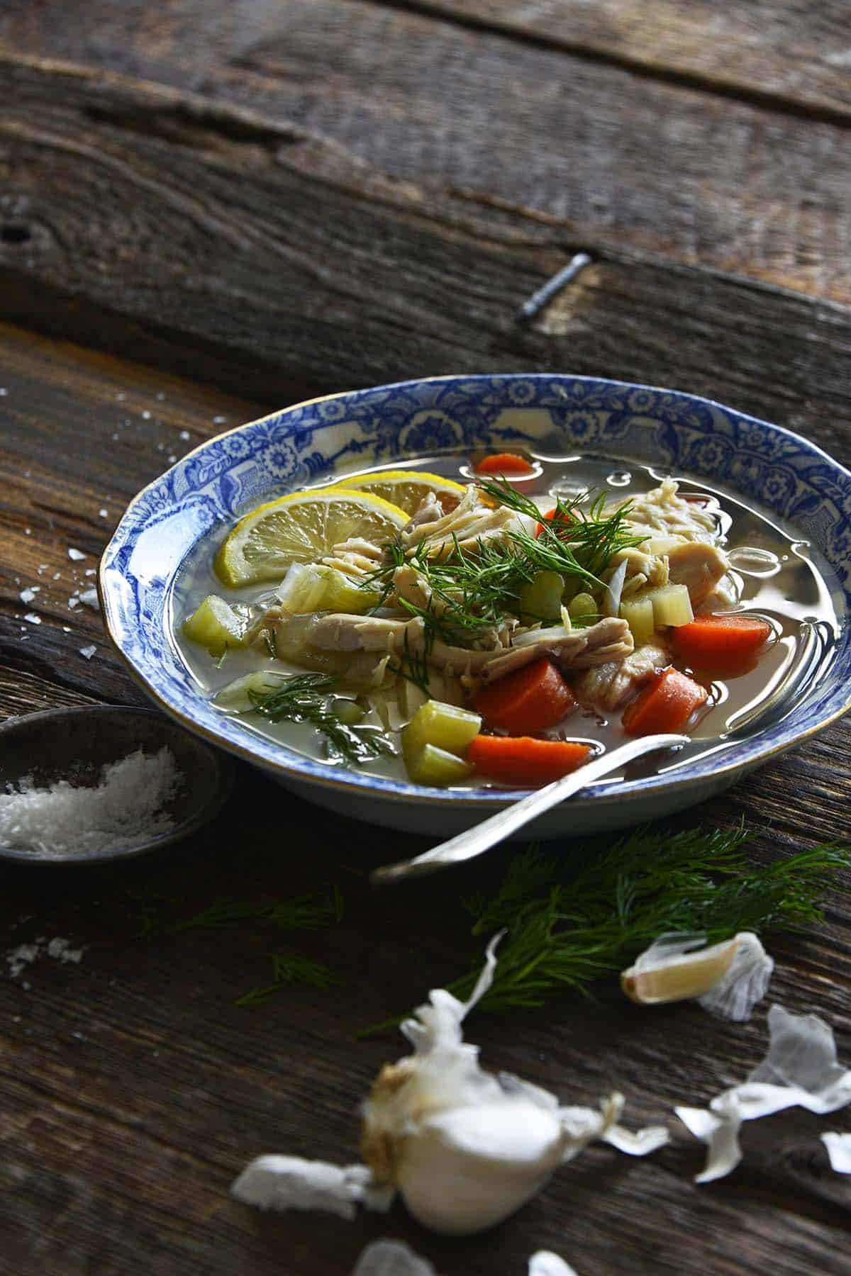 front view of bowl of best chicken soup recipe with dill and lemon