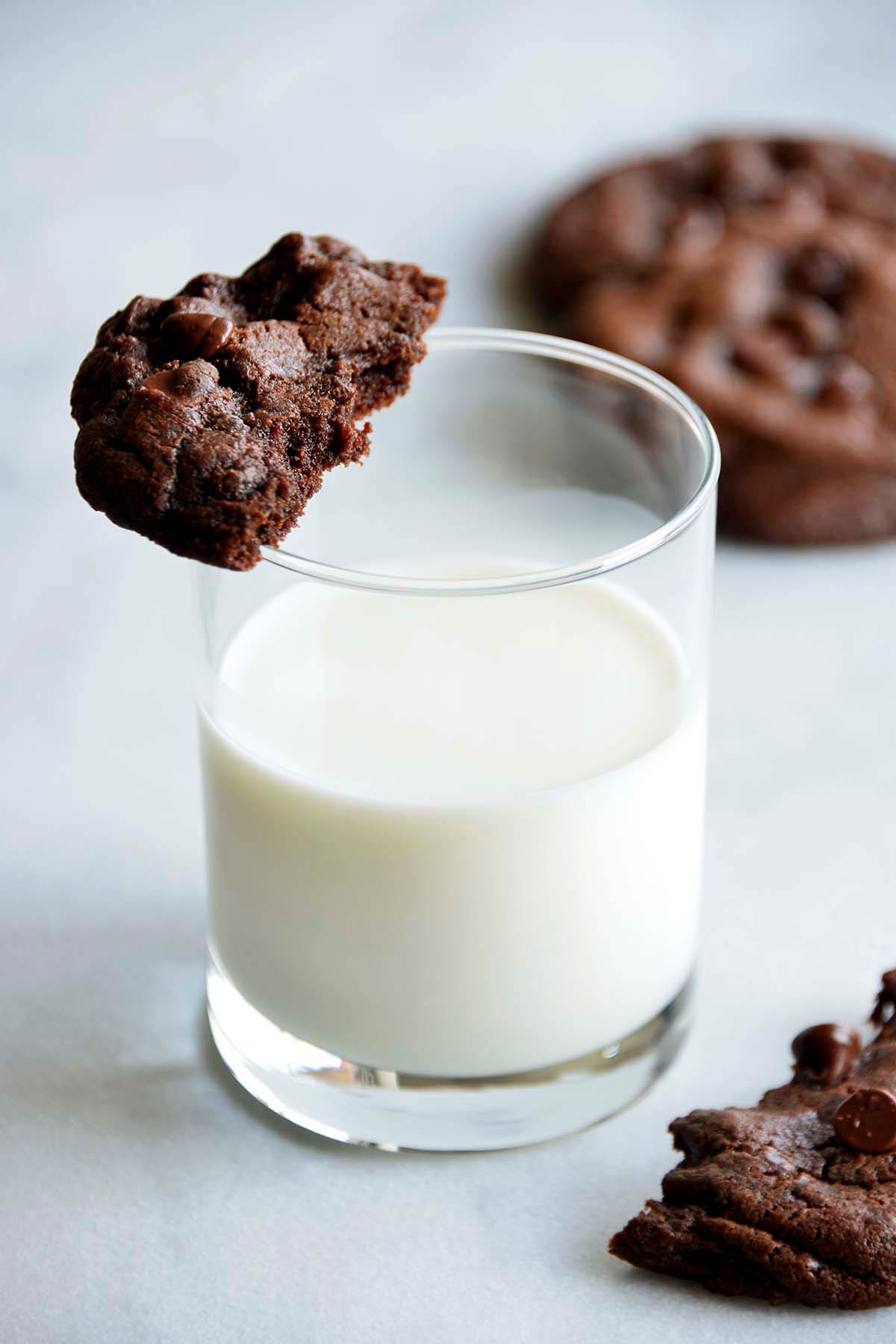 glass of cold milk with chewy chocolate chip cookies