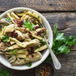 Creamy Mushroom Chicken Pasta in White Bowl with Vintage Fork