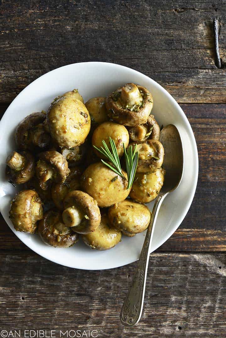 overhead view of garlic roasted mushrooms in white bowl