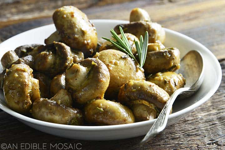 roasted button mushrooms with garlic in white dish