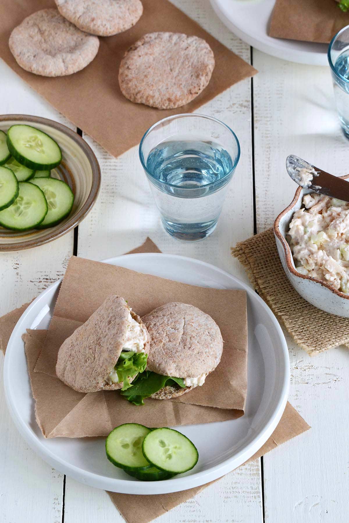 lunch spread with the best canned chicken salad pita sandwiches and sliced cucumbers
