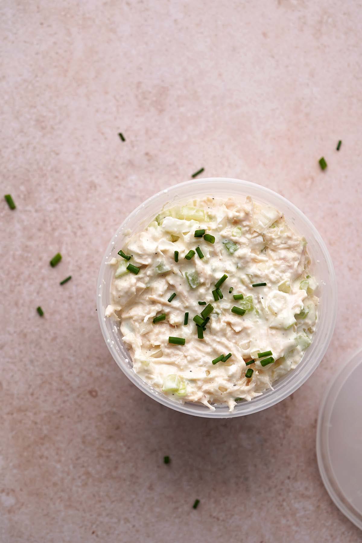 plastic deli container with canned chicken salad