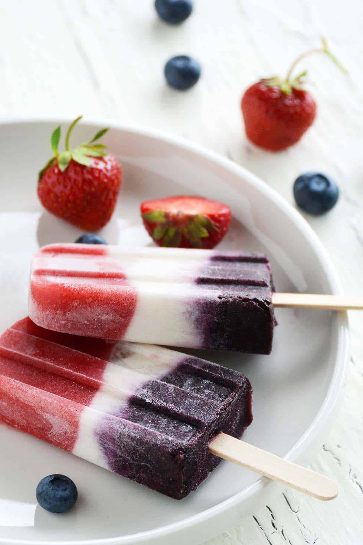 red white and blue popsicles made with berries