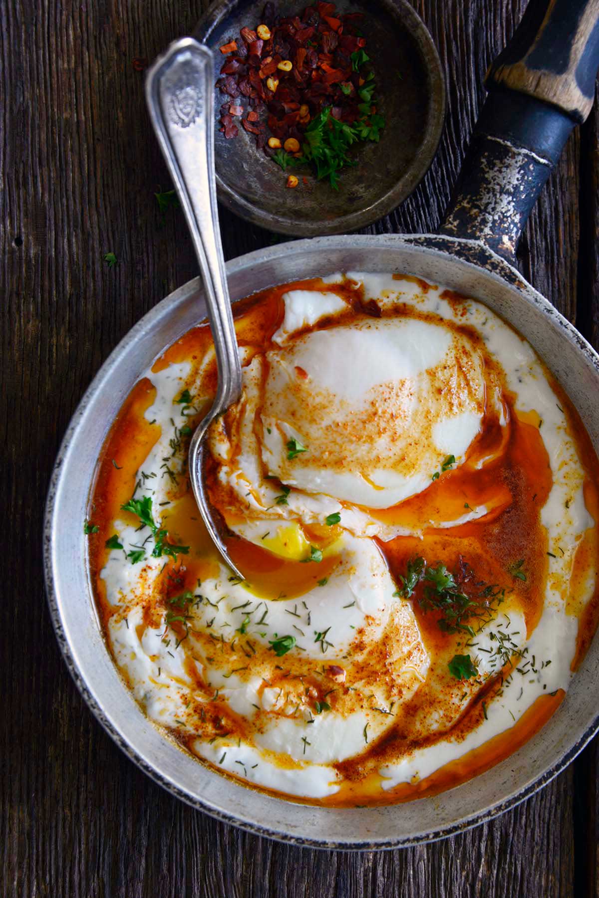 top view of Turkish breakfast poached eggs with garlic yogurt and spiced butter sauce