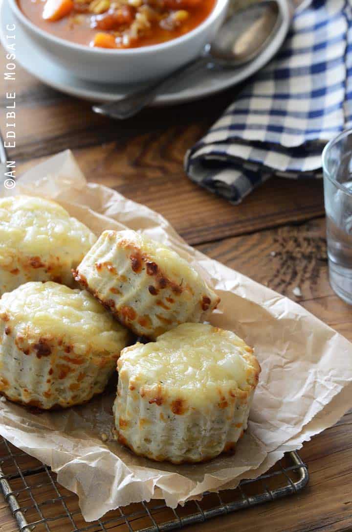 Swiss Cheese and Thyme Scones Recipe on Cutting Board with Bowl of Soup in Background