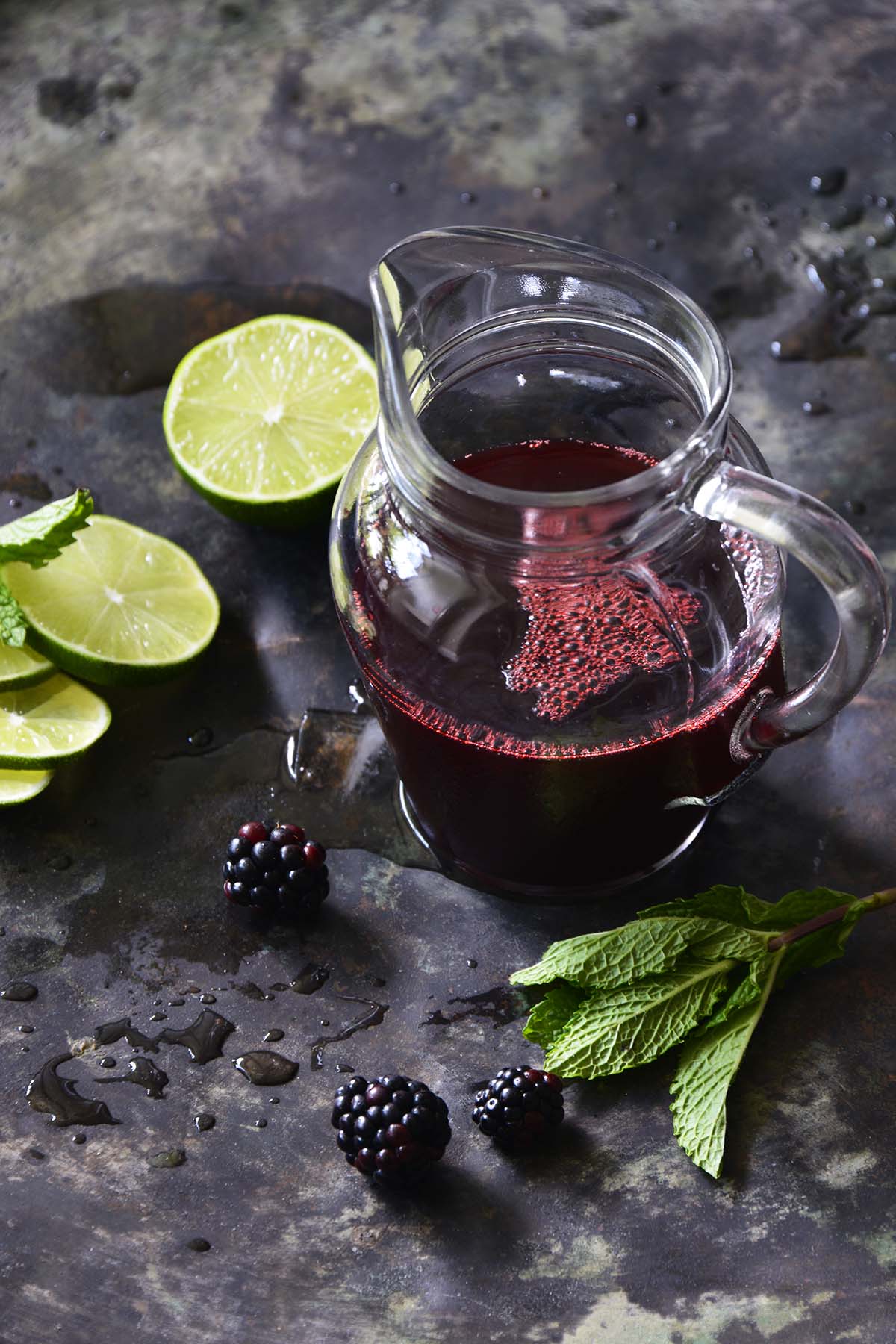glass pitcher with homemade blackberry syrup for drinks