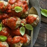 Beef Meatballs with Tomato Sauce on Metal Platter with Basil