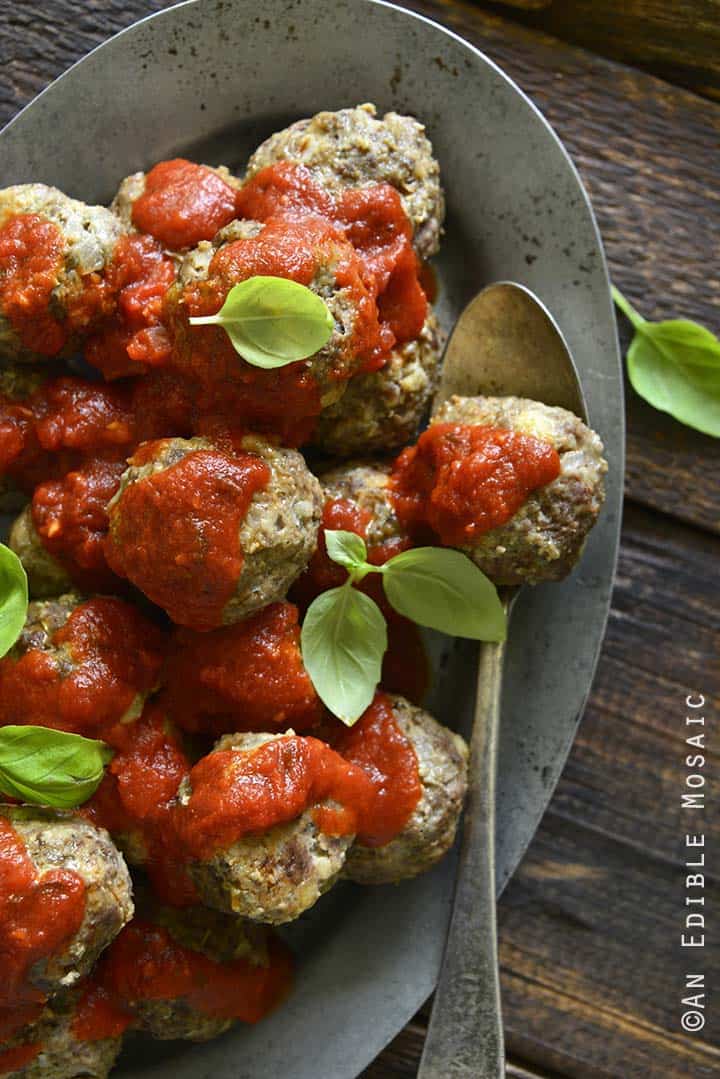 Beef Meatballs with Tomato Sauce on Metal Platter with Basil