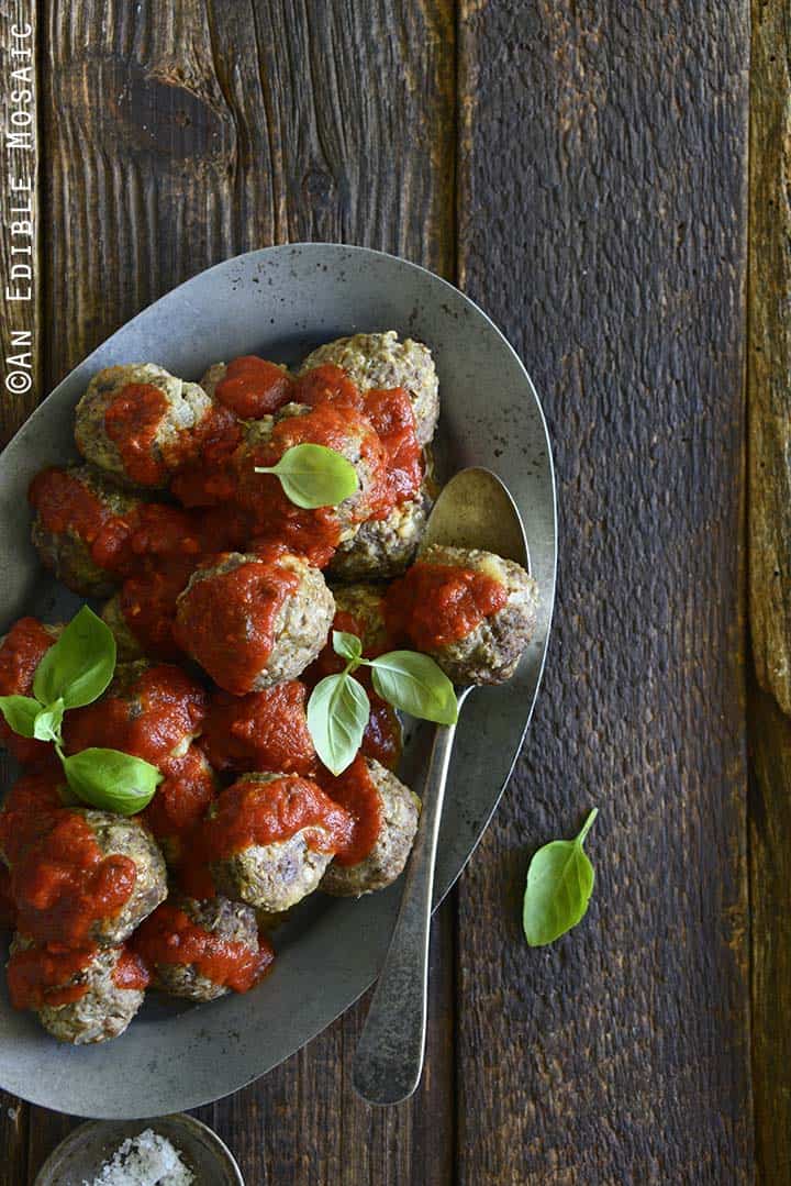 Classic Meatball Recipe with Tomato Sauce on Metal Tray on Dark Wood Table