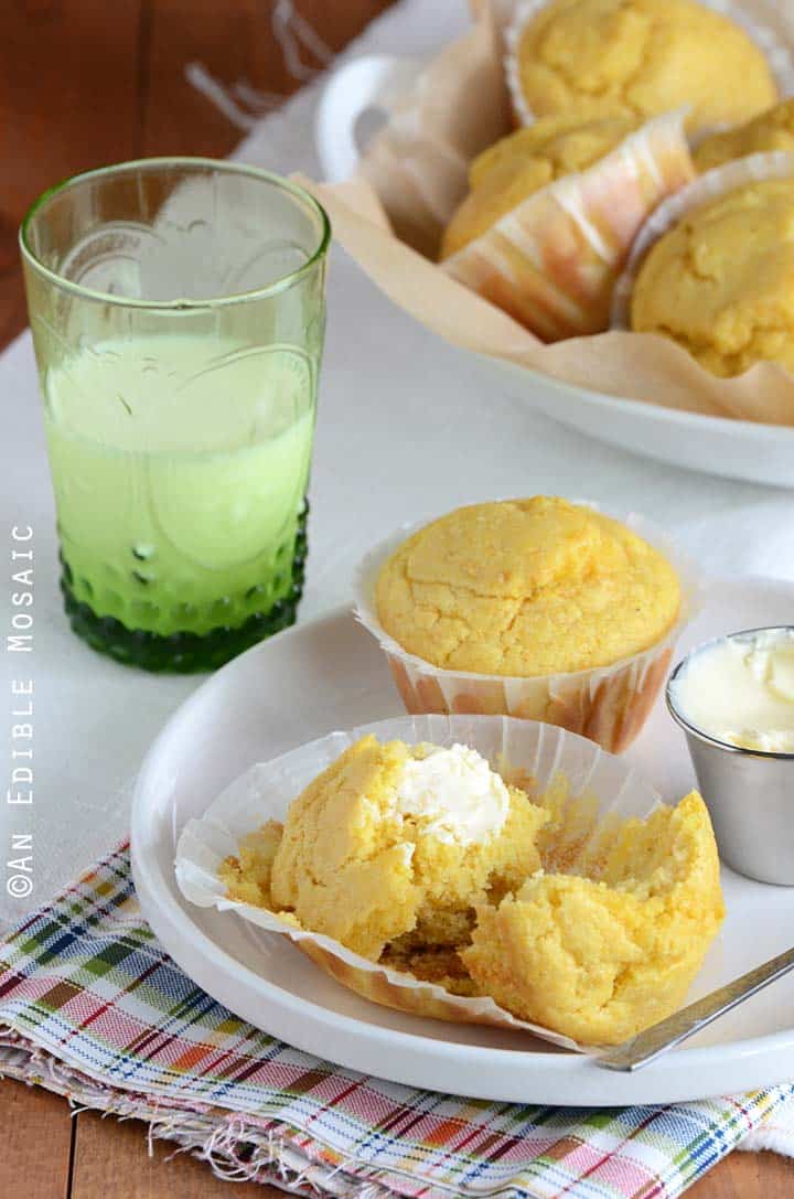 Buttered Cornbread Muffin Split in Half on White Plate