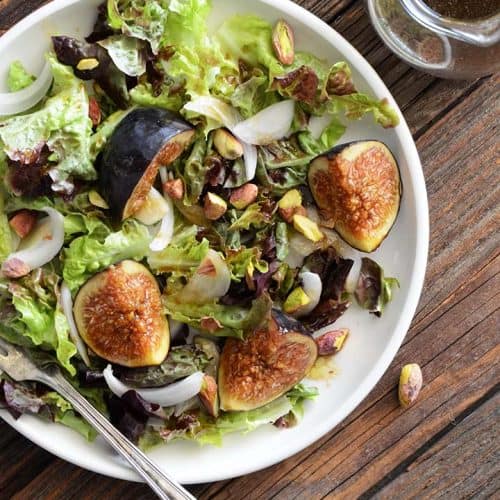 Top View of Fresh Fig Salad Recipe on White Plate on Wooden Table