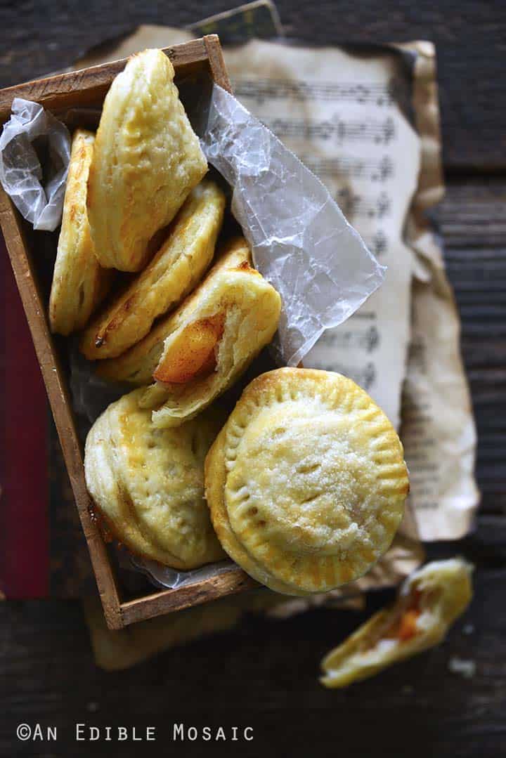 Peach Hand Pie Recipe in Wooden Box on Top of Vintage Music Sheets