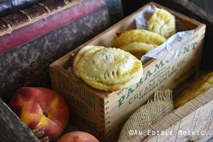 Front View of Small Peach Pies Stacked in Wooden Box