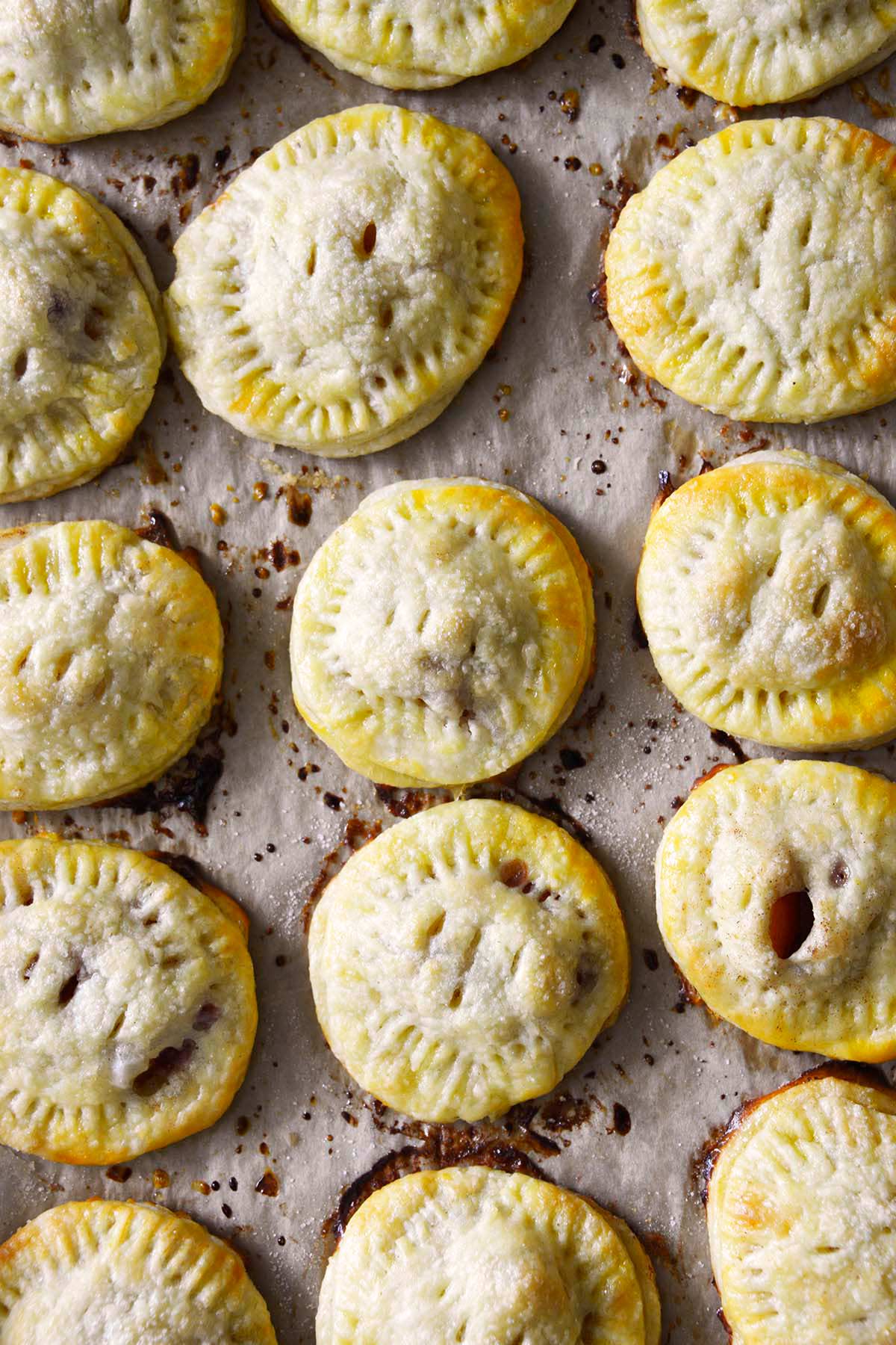 homemade fresh peach hand pies with flaky butter crust on baking tray