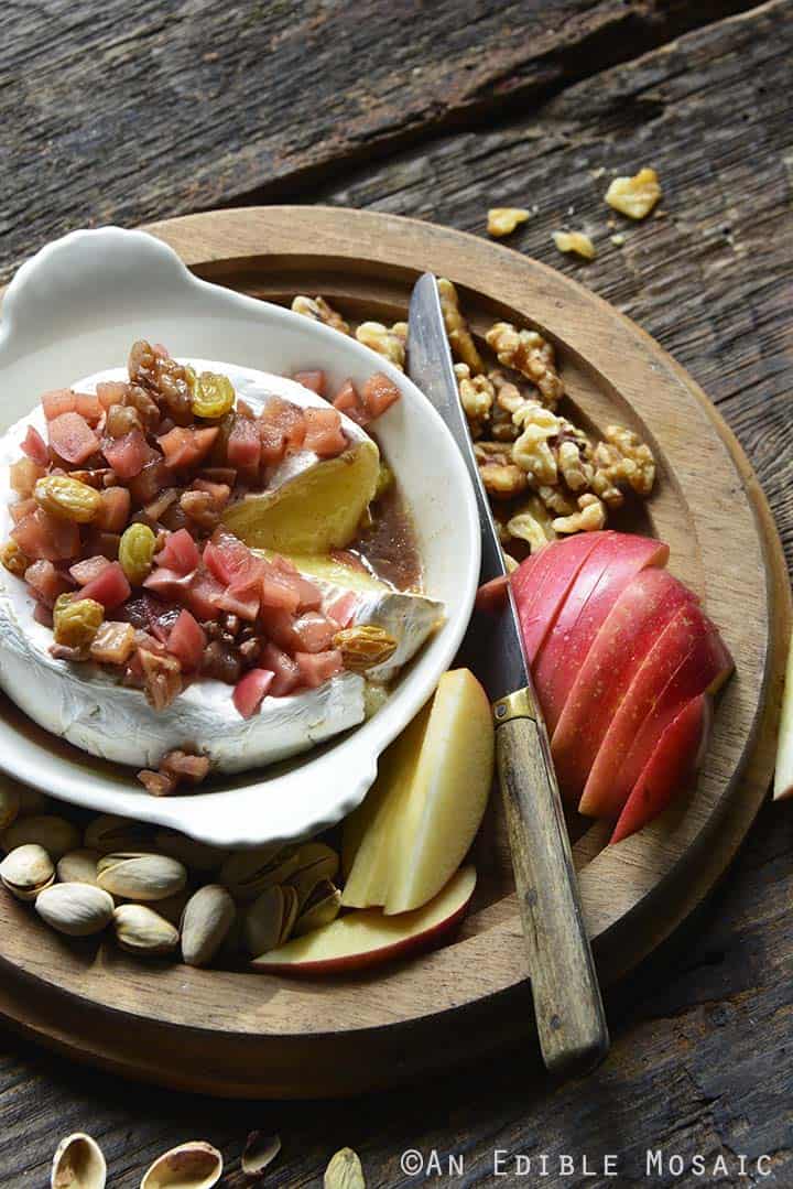 Baked Brie with Apple in White Dish on Wooden Tray with Apple