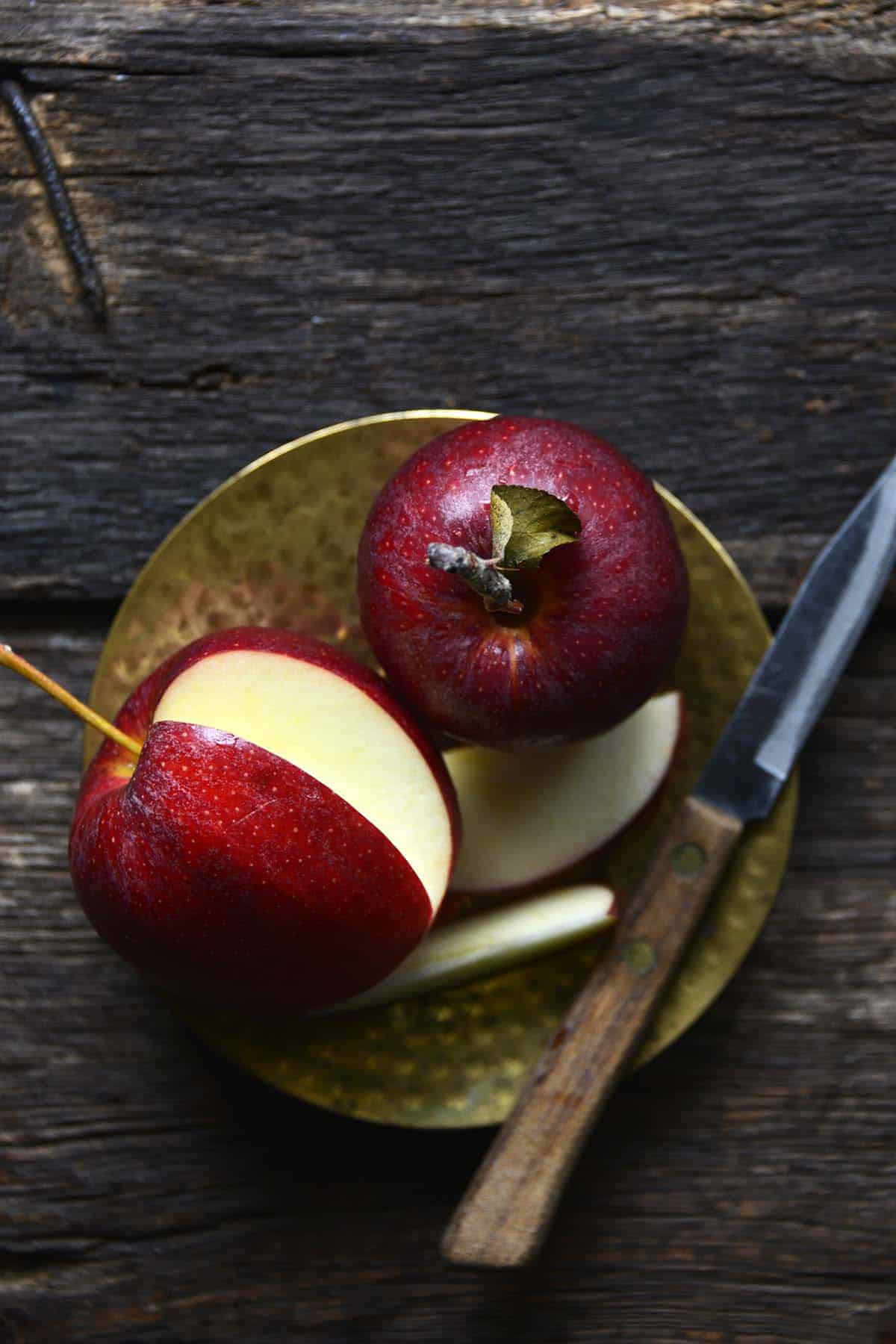 overhead view of 2 apples on small plate for making chutney