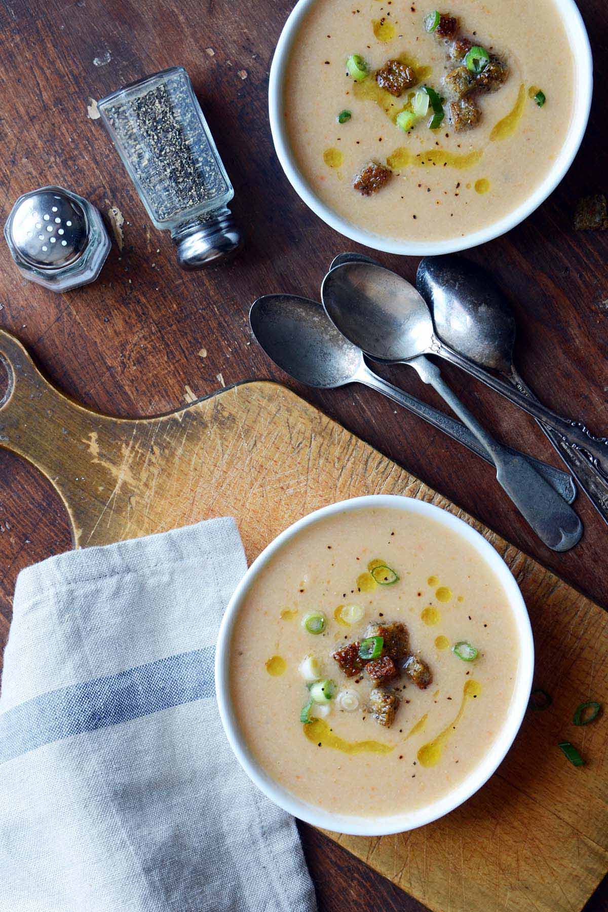 smoky cauliflower cheese beer soup recipe on rustic pub table