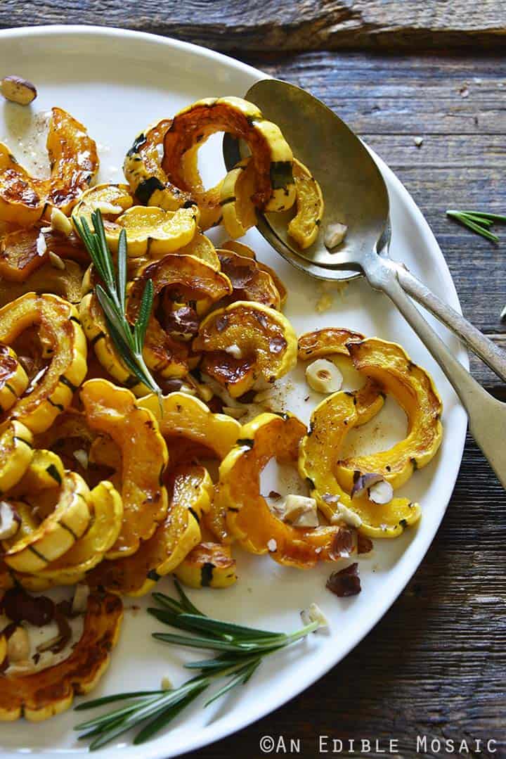 Roasted Delicata Squash with Rosemary Brown Butter and Hazelnuts Recipe on White Plate with Vintage Spoons