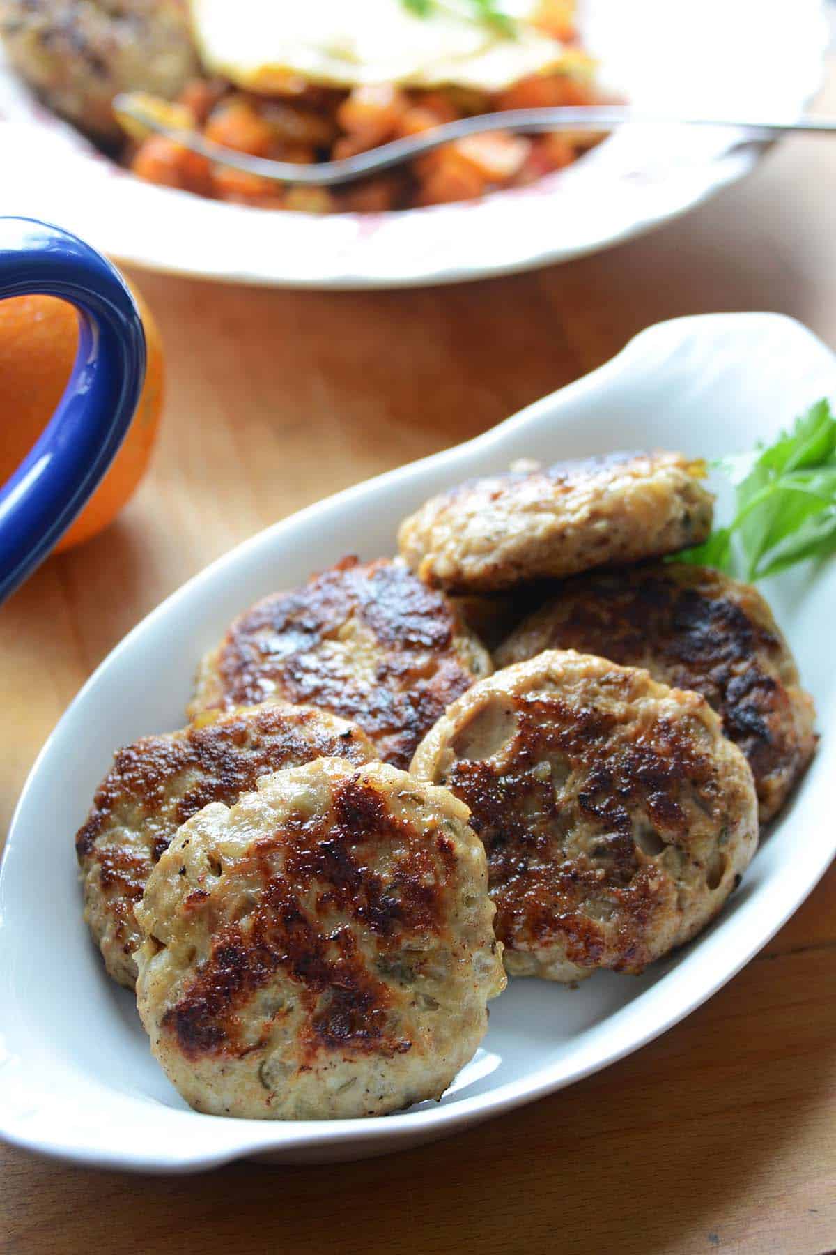 close up front view of dish of breakfast chicken sausage patties