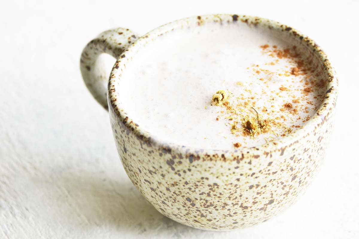 front view of chamomile latte in speckled stoneware mug