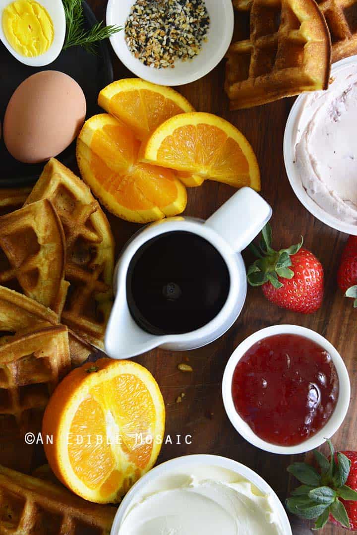 Close Up of Waffles Oranges and Syrup on Breakfast Board