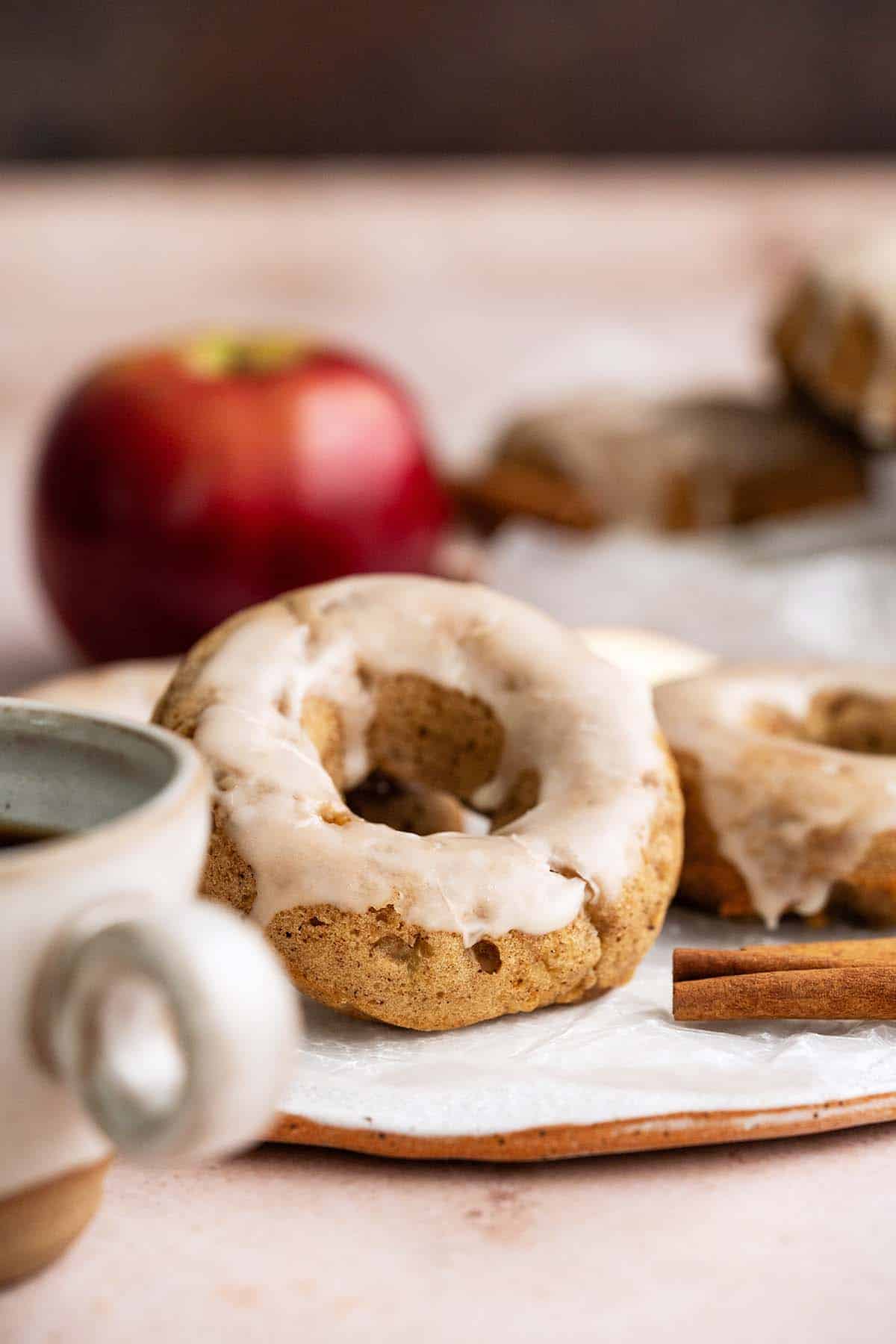 baked apple cider doughnuts with cup of coffee and fresh apples