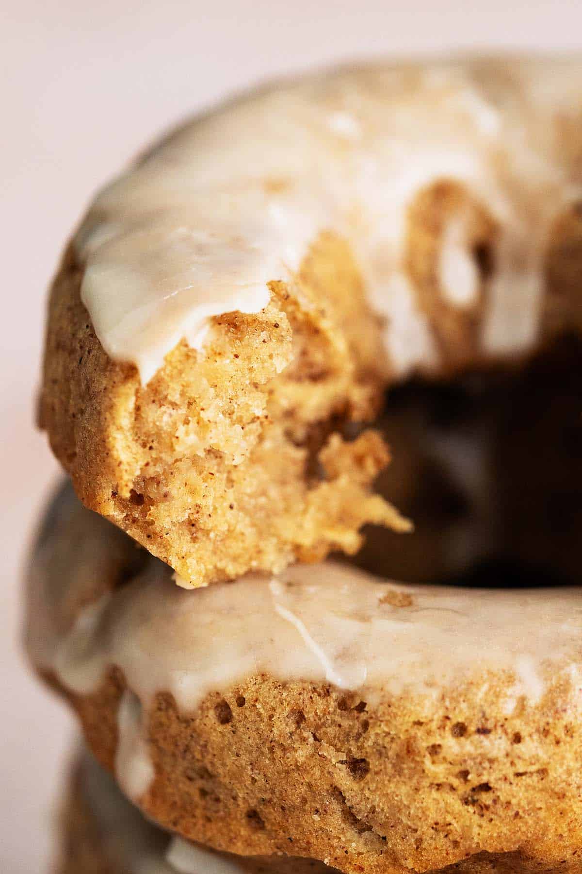 close up of stack of apple cider donuts with bite out of one