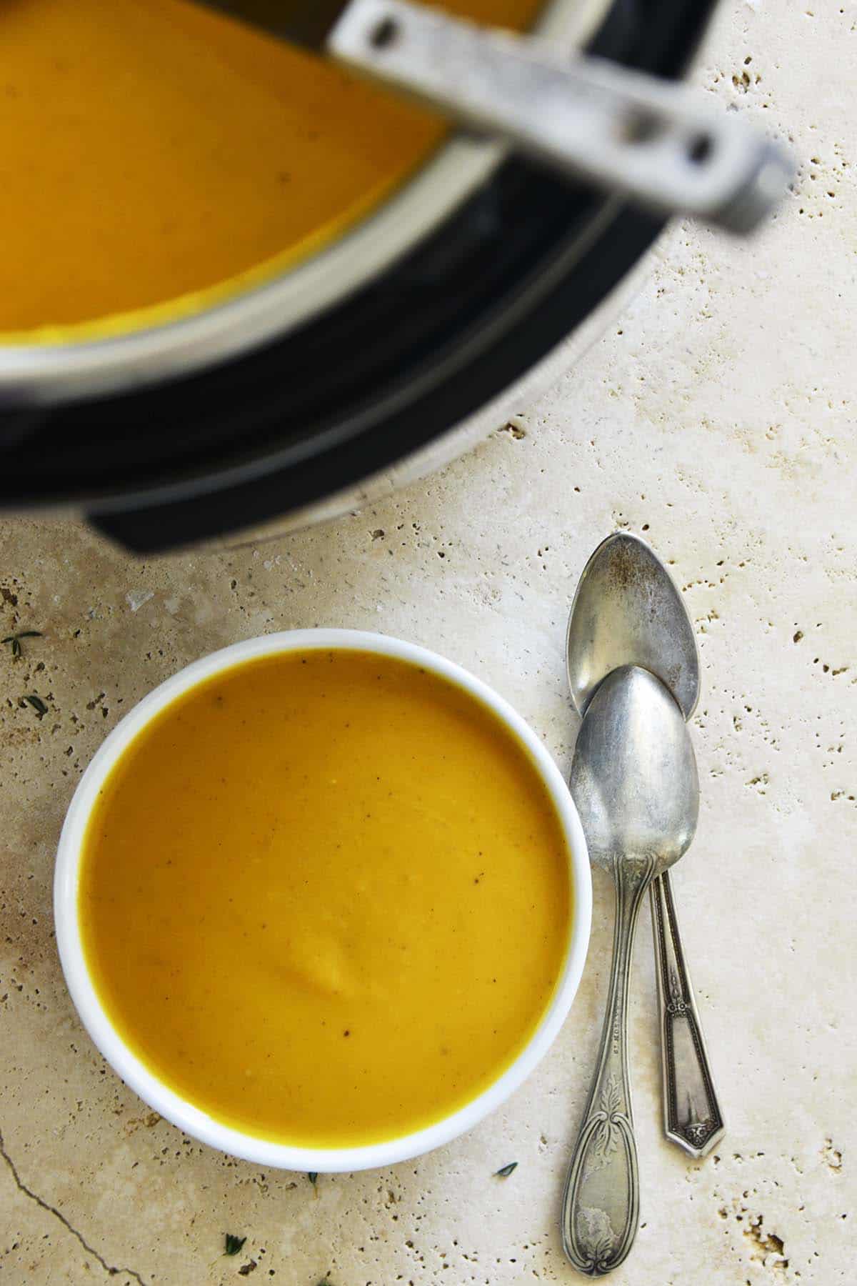 top view of silky smooth butternut soup with instant pot next to it