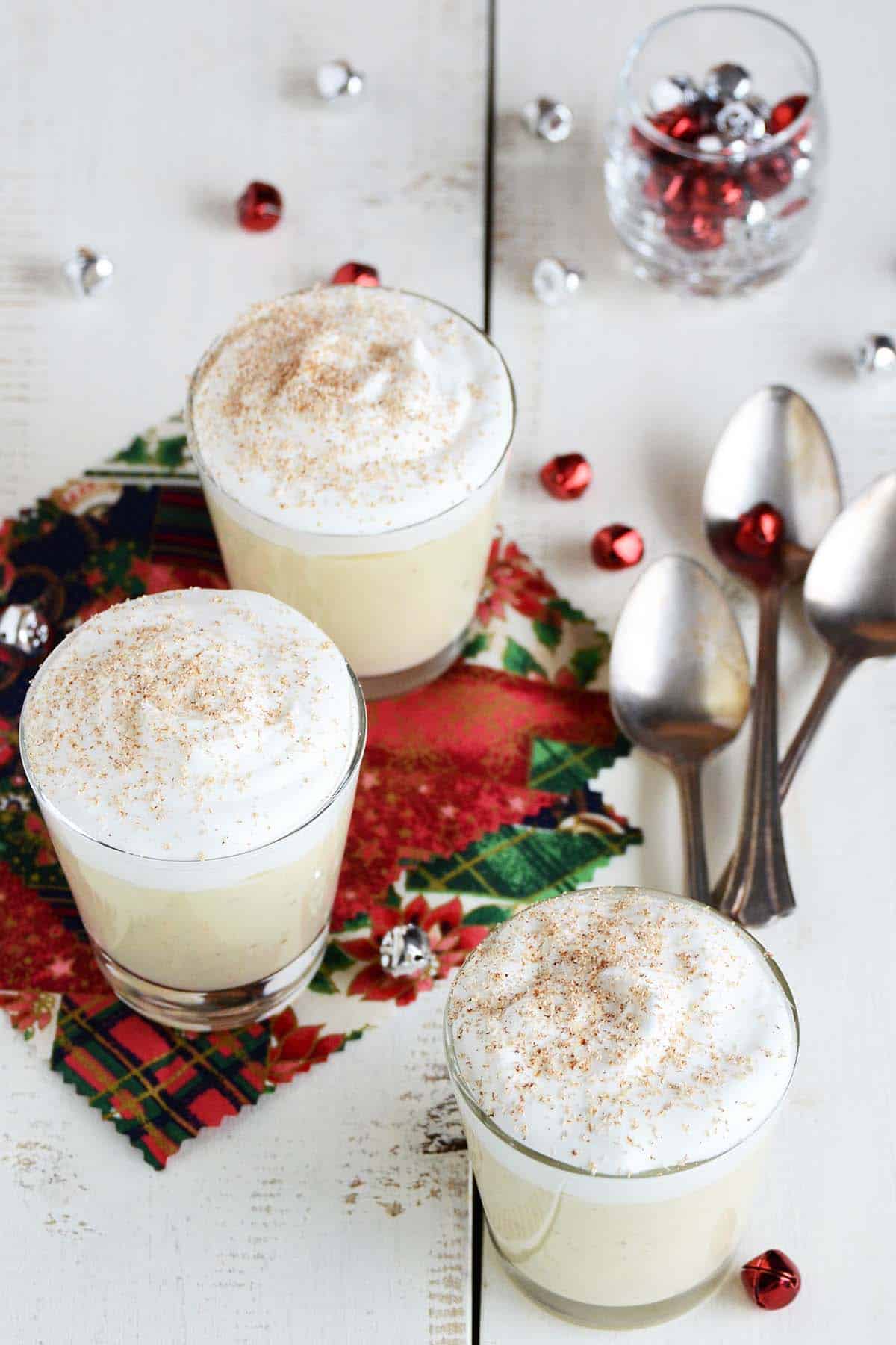 3 cups of eggnog pudding with festive christmas decorations