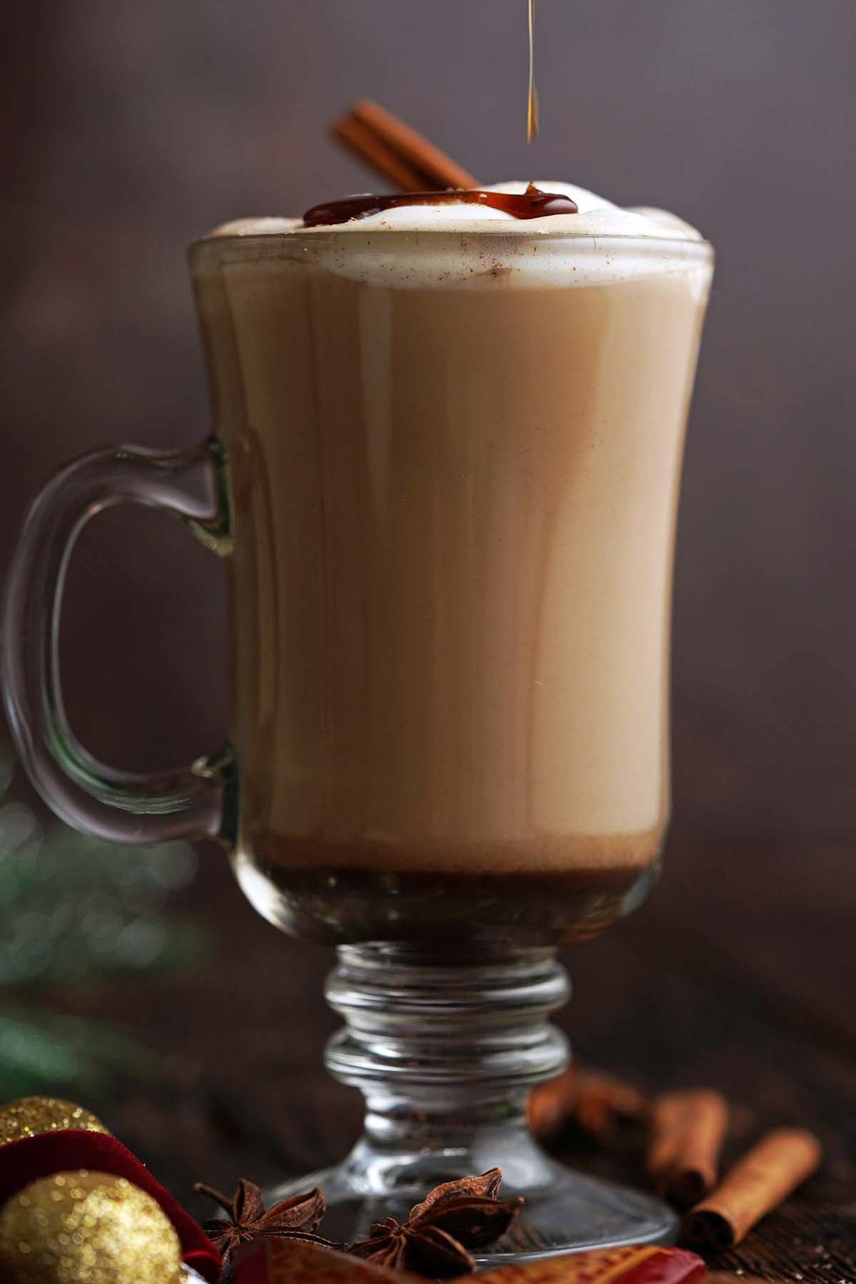 drizzling ginger spice simple syrup onto latte