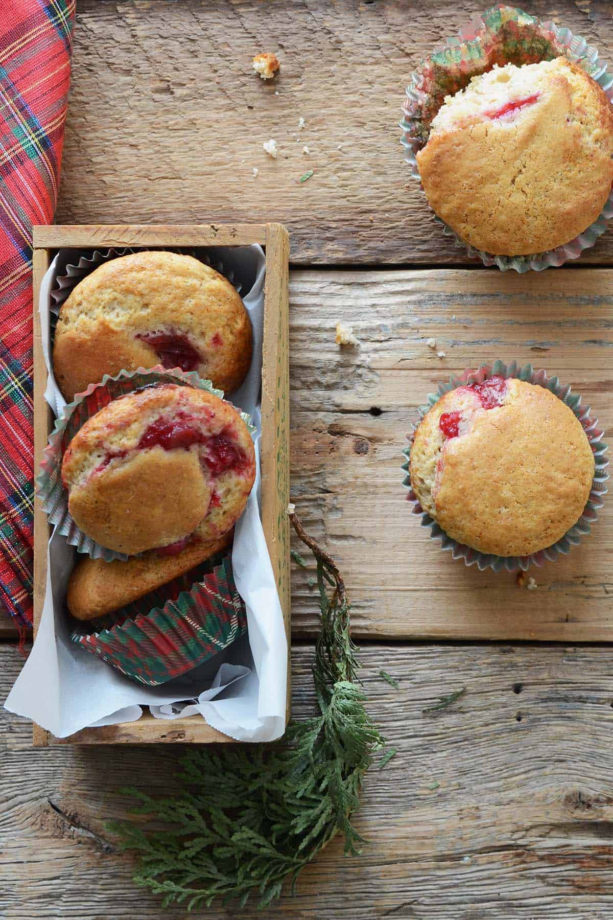 festive eggnog muffins with cranberry sauce on wooden table