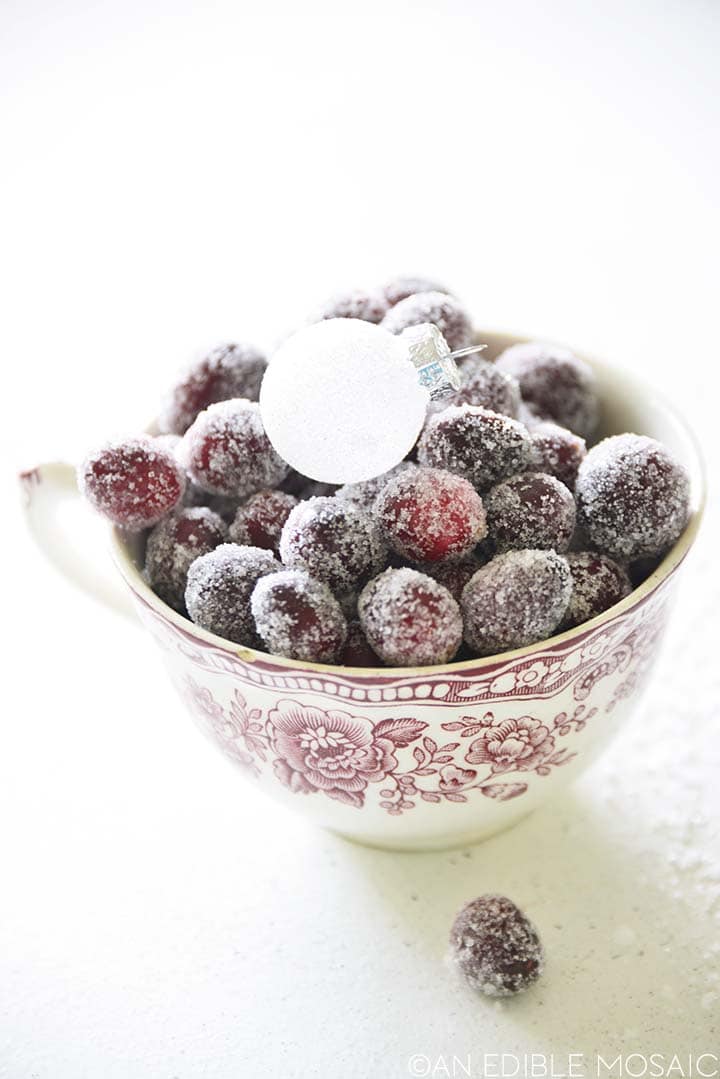 sugared cranberries in red and white tea cup