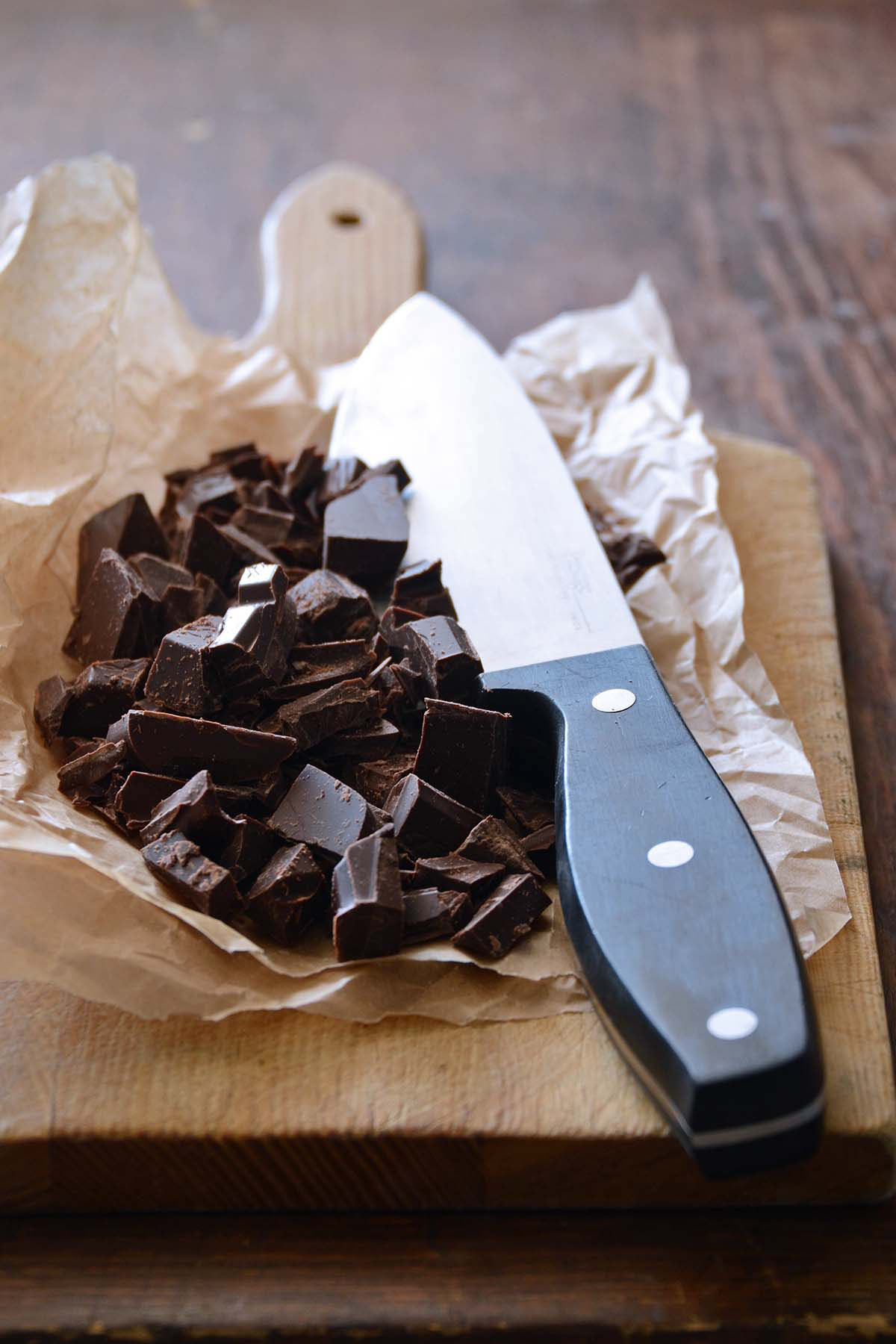 chopped chocolate on wooden cutting board