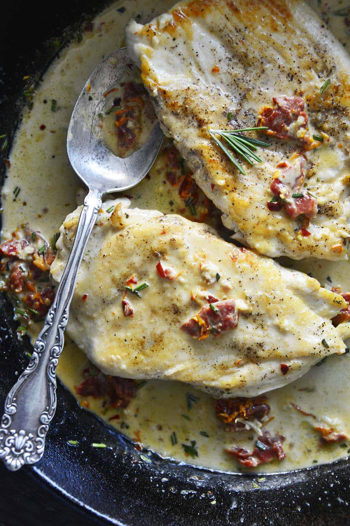 seared chicken cutlets in creamy sauce in cast iron skillet