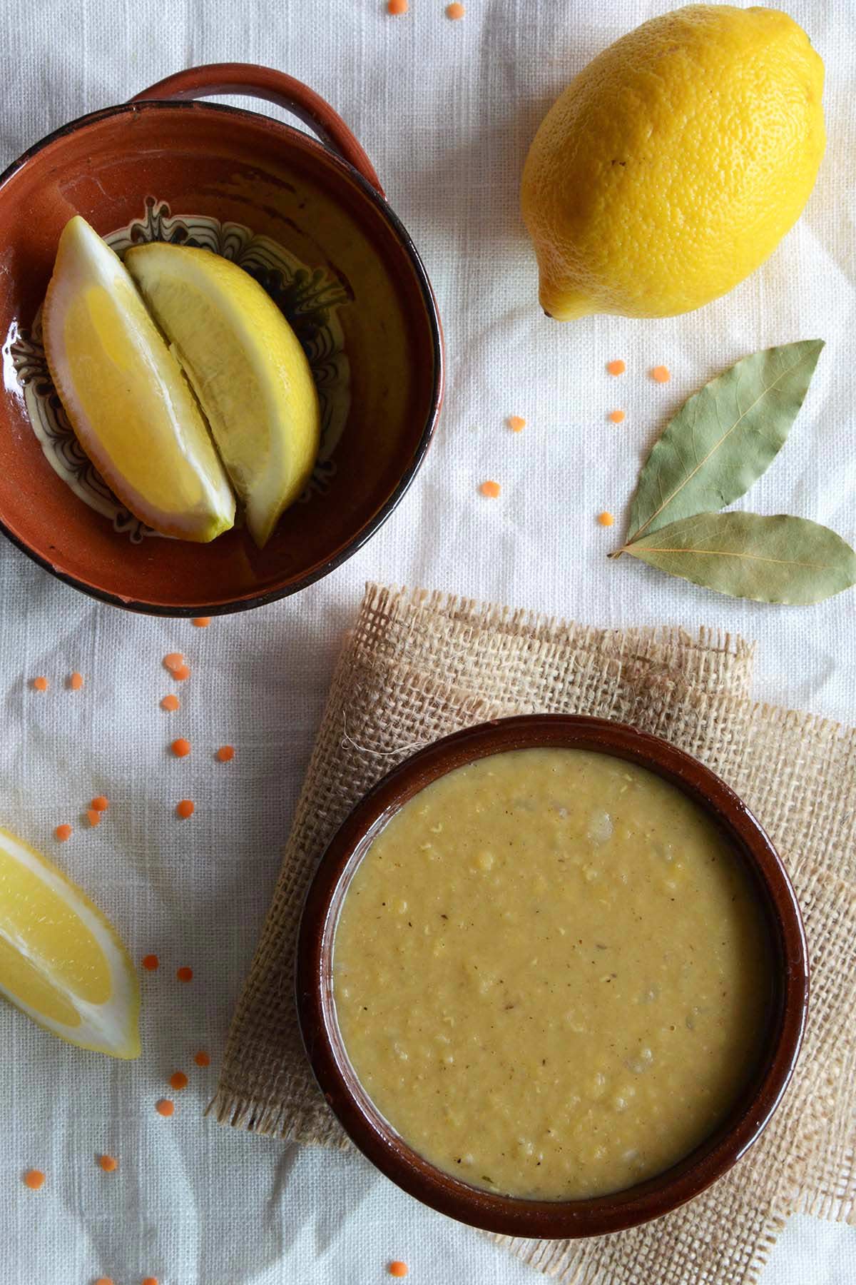 bowl of simple arabic red lentil soup with fresh lemon on the side