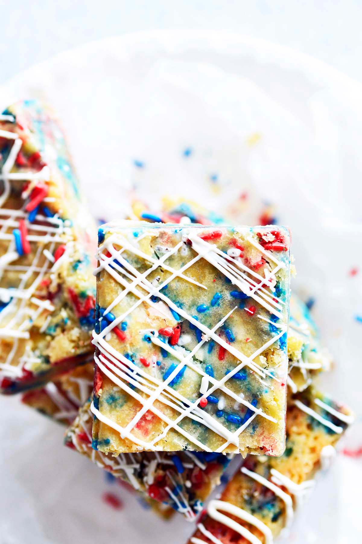 pile of gooey blondie bar cookies with red white and blue sprinkles