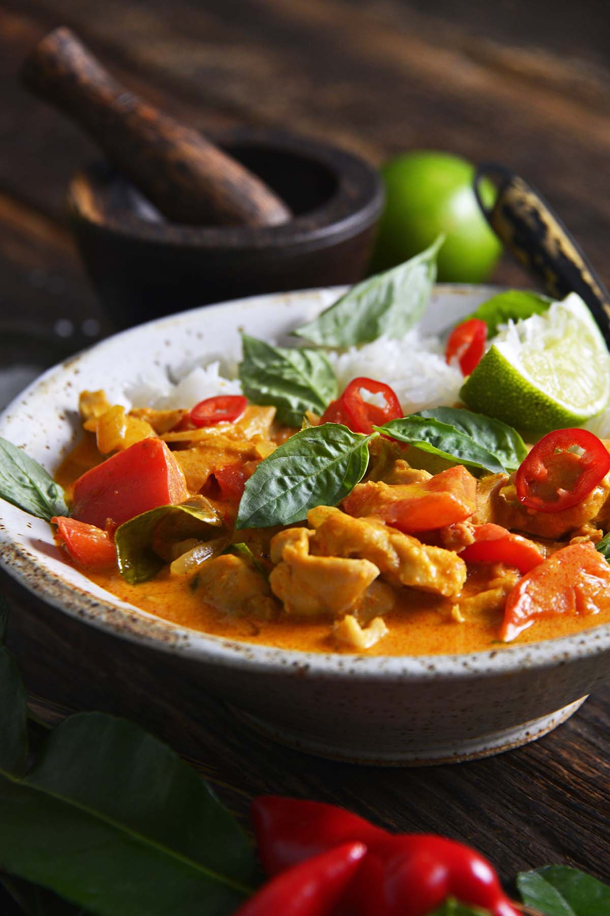 front view of Panang Curry with chicken and jasmine rice in stoneware bowl