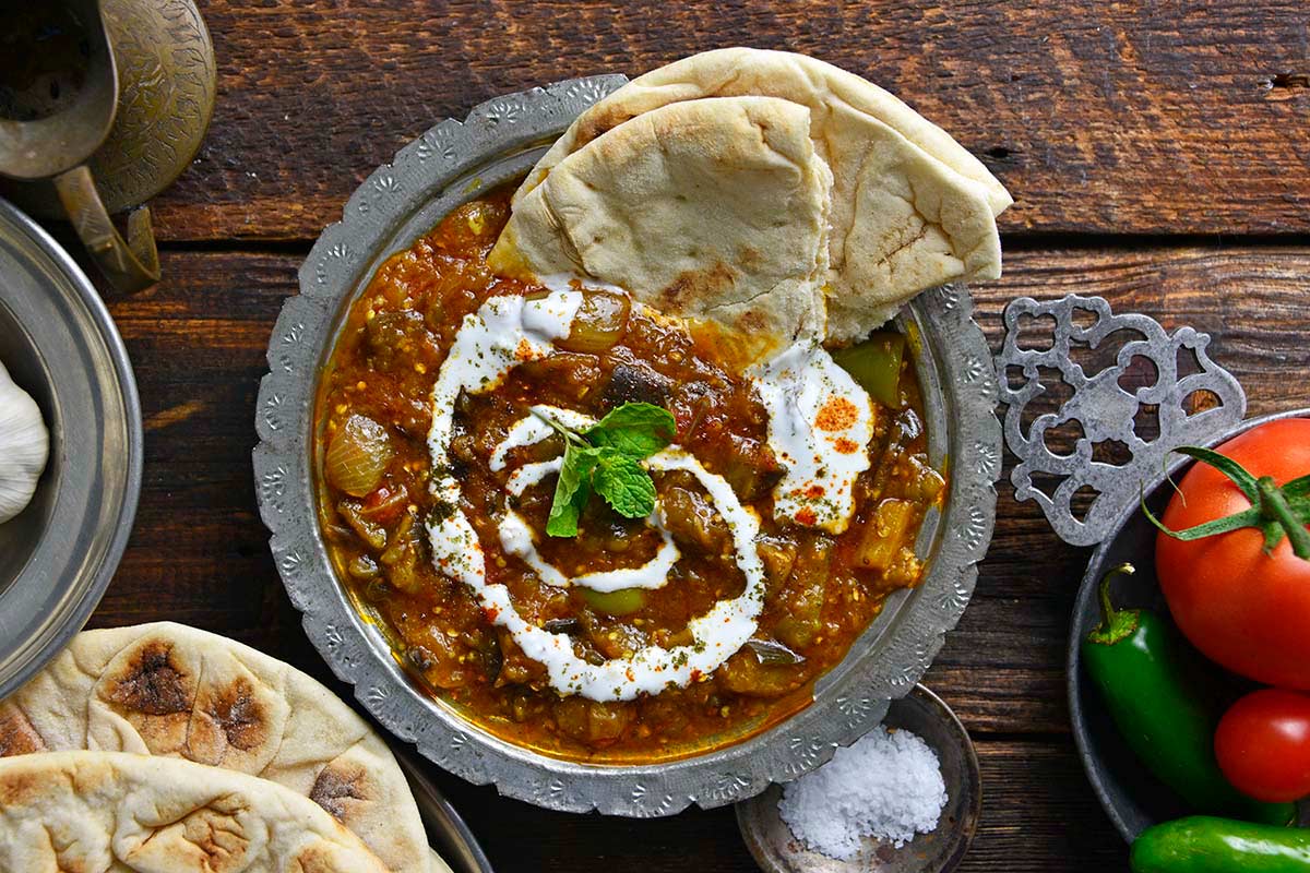 authentic borani banjan or borani bademjan on rustic dark wooden table