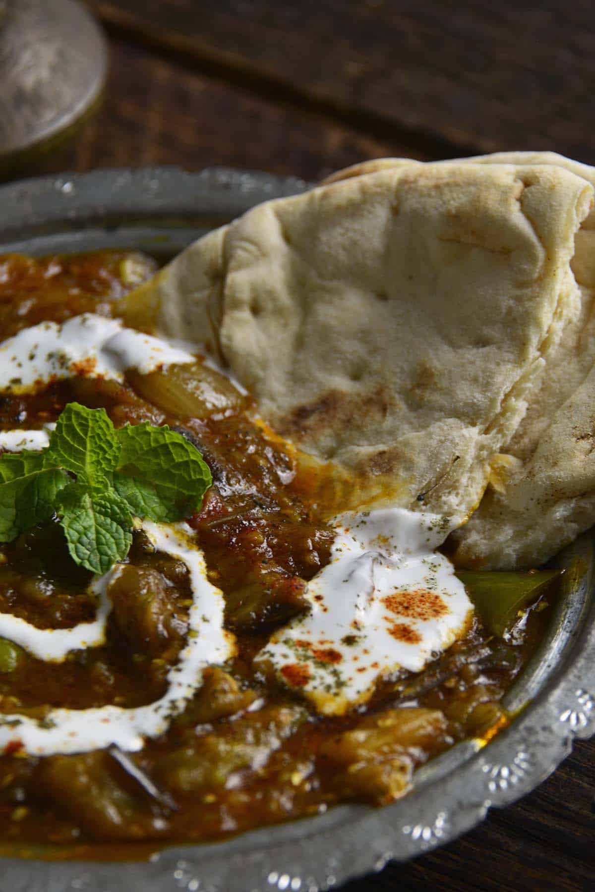 close up front view of afghan eggplant dip with yogurt and spices