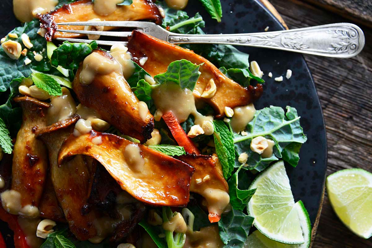 glazed king oyster mushroom salad with kale and hazelnuts