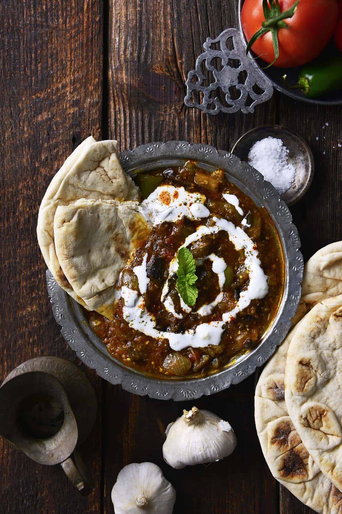 naan in eggplant dip with yogurt sauce