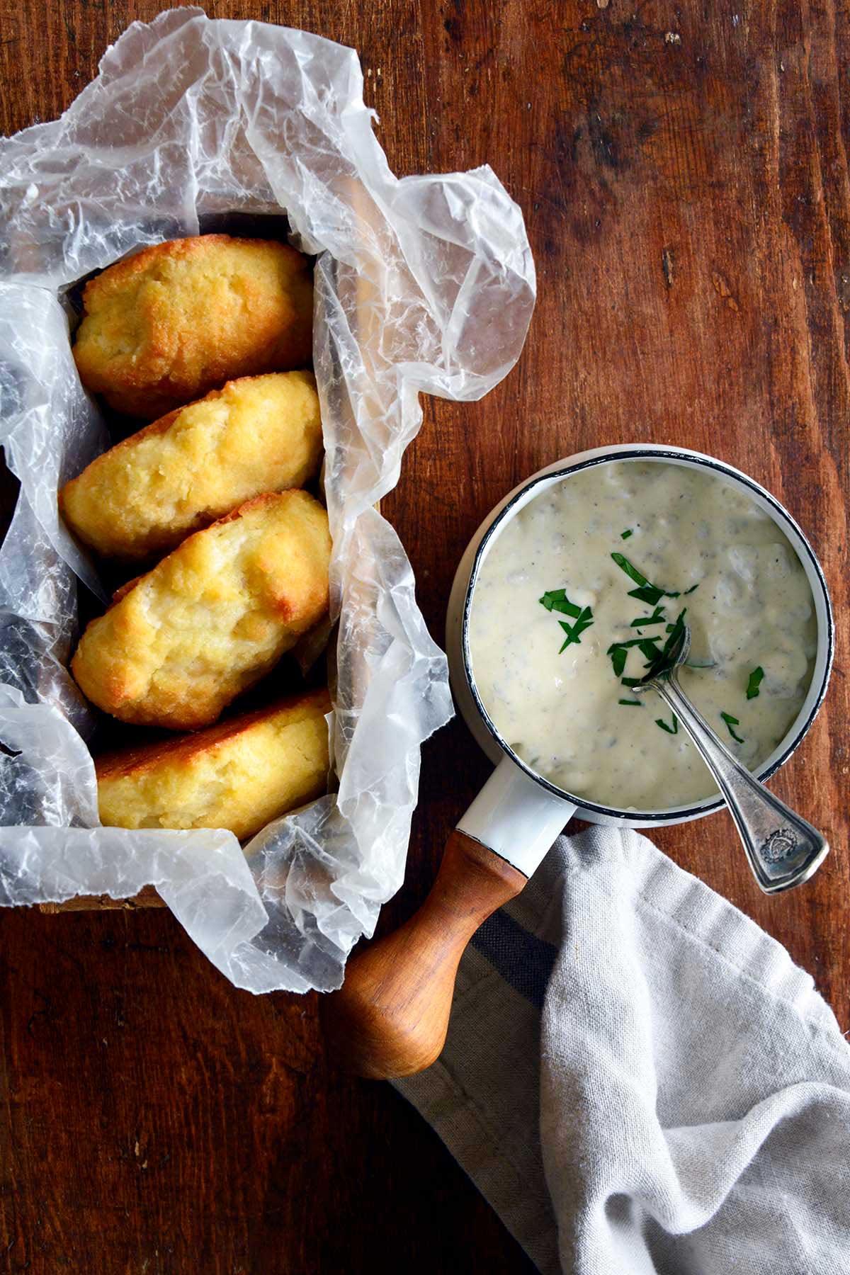 top view of keto fluffy biscuits with saucepan of southern sausage gravy