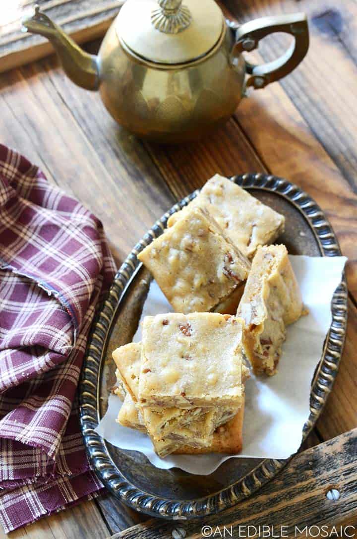 butterbeer blondies recipe on antique metal tray with tea pot
