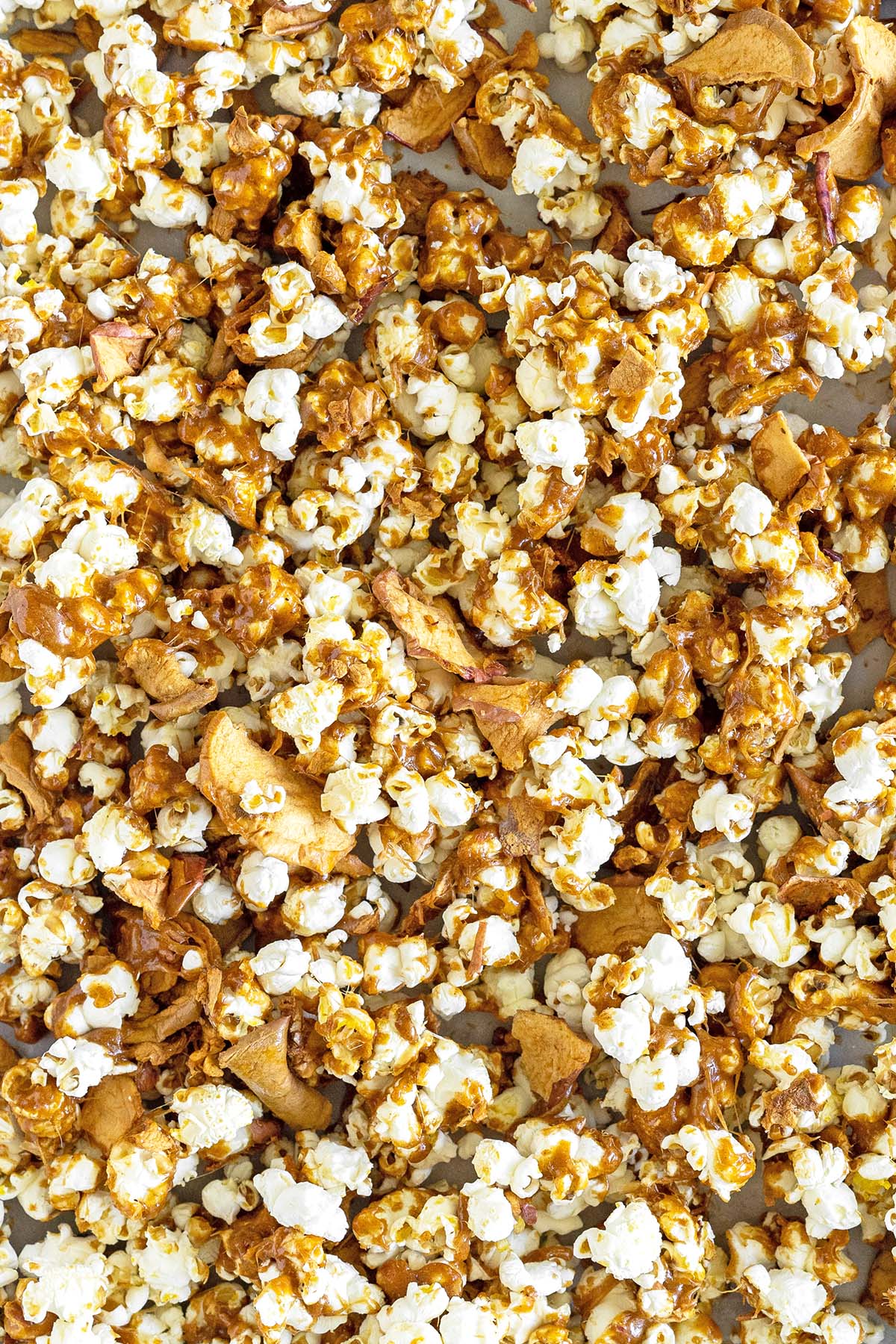close up top view of tray of spiced caramel apple popcorn