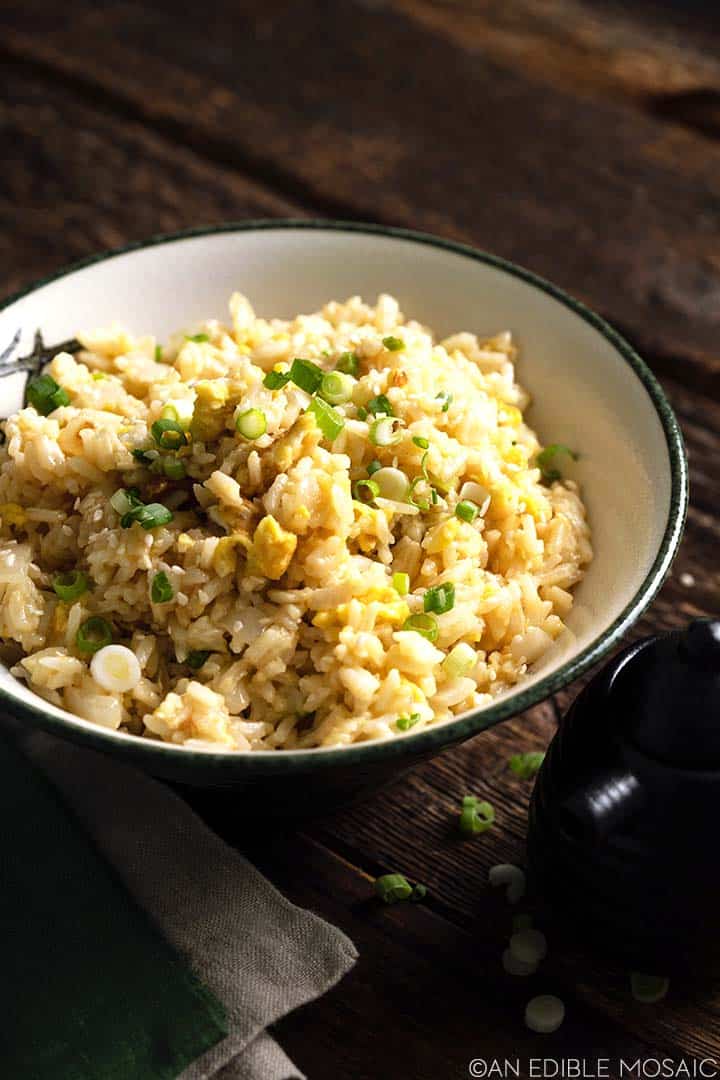 yakimeshi in decorative rice bowl on rustic dark wooden table