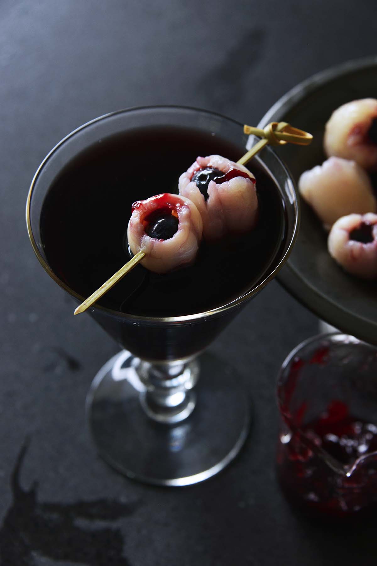 halloween cocktail with bloody eyeball in fancy glass