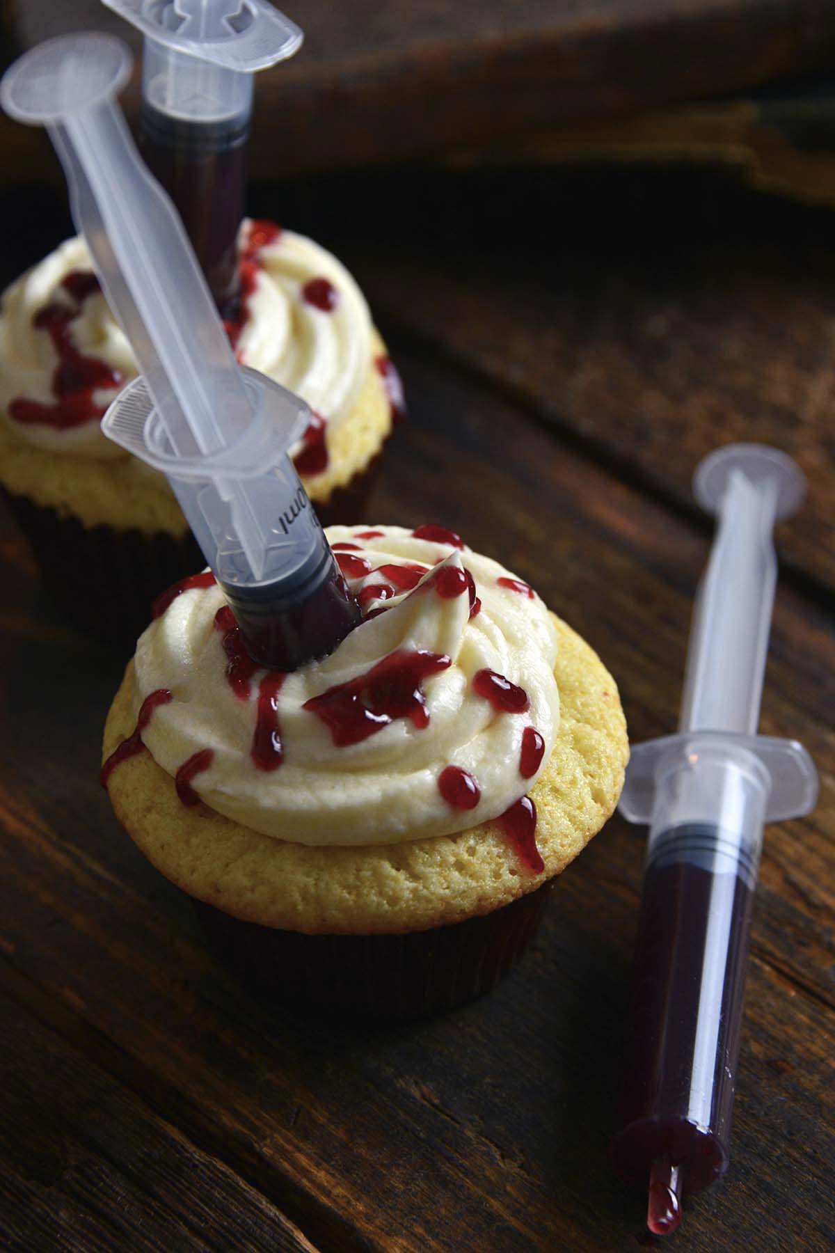 raspberry jam filled vanilla cupcakes with frosting