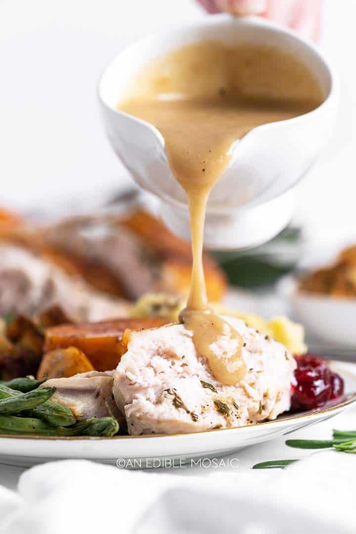 pouring gravy onto turkey