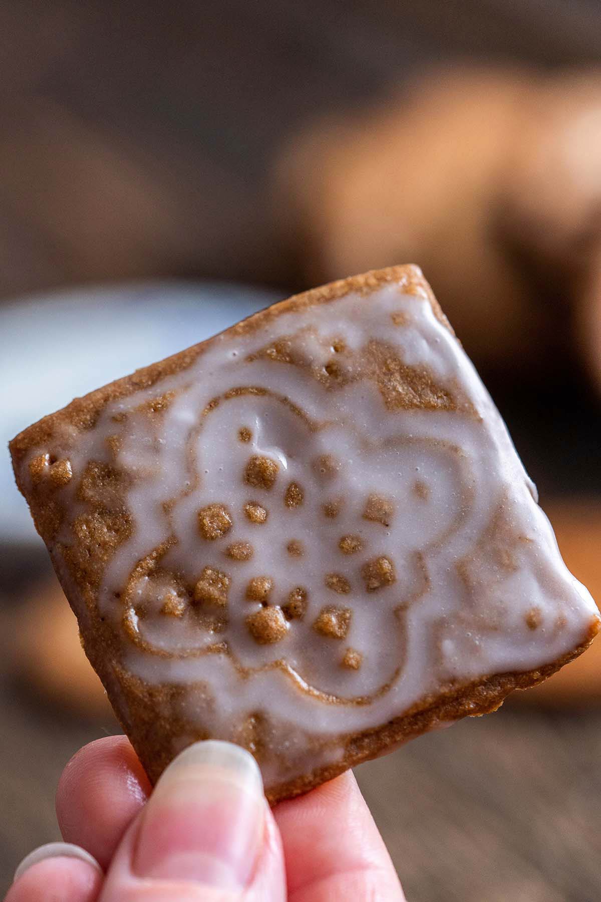 hand holding iced Speculaas cookie